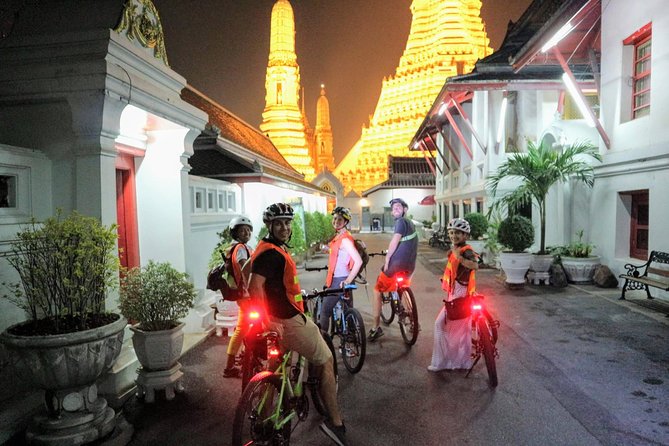 Bike Bangkok at Night with Thai Dinner - Wat Arun after dark, with the river ahead
