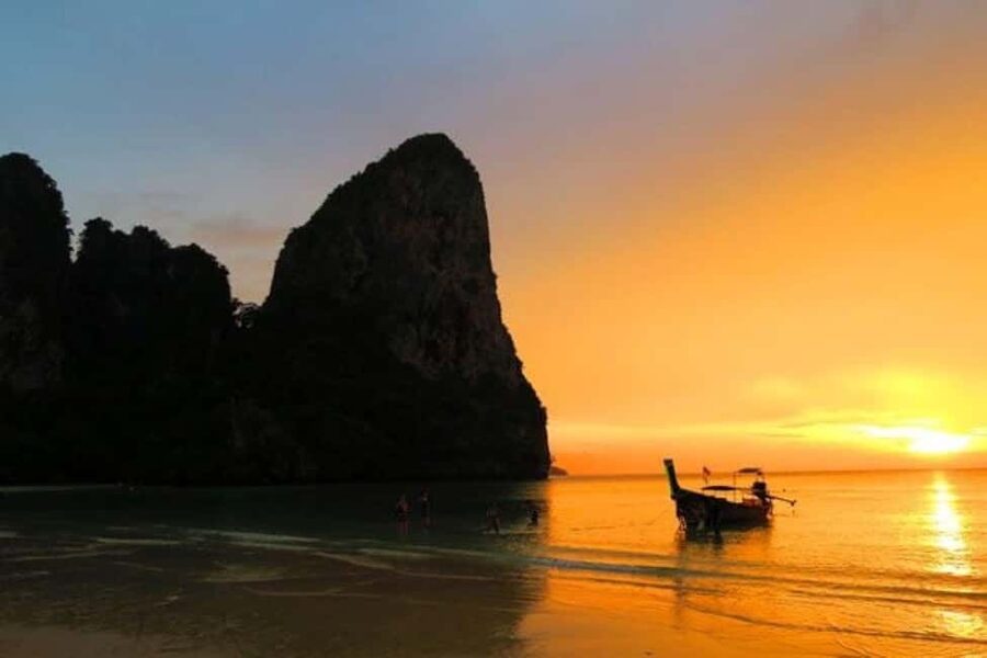 Krabi: Railay Sunset and Bioluminescent Plankton Tour - Riding a traditional longtail boat to Railay