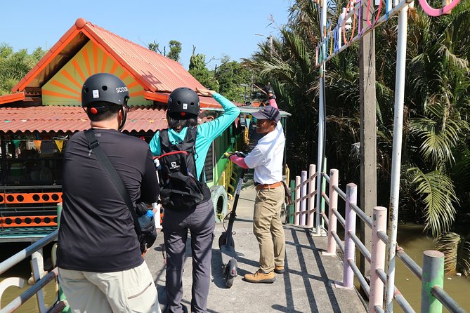 Take a E-Scooter Ride in Bangkok's Jungle - Temples, village roads, and the Ganesh Shrine